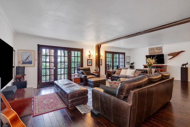 living room featuring crown molding, a textured ceiling, dark hardwood / wood-style flooring, and french doors