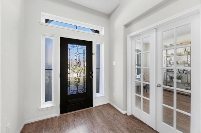 foyer entrance featuring french doors and hardwood / wood-style floors