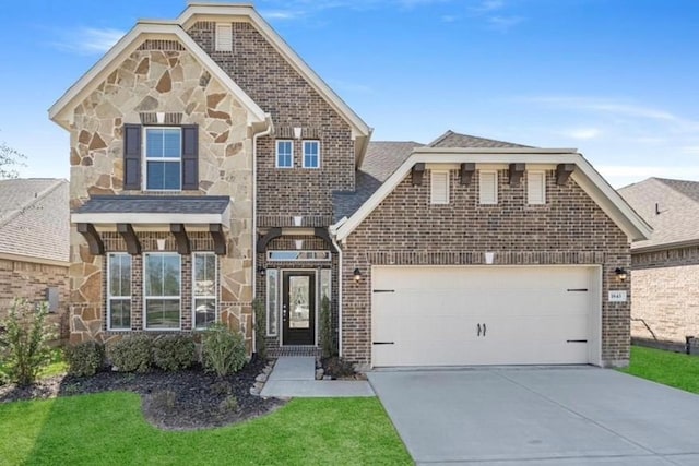 view of front of property featuring a garage and a front lawn