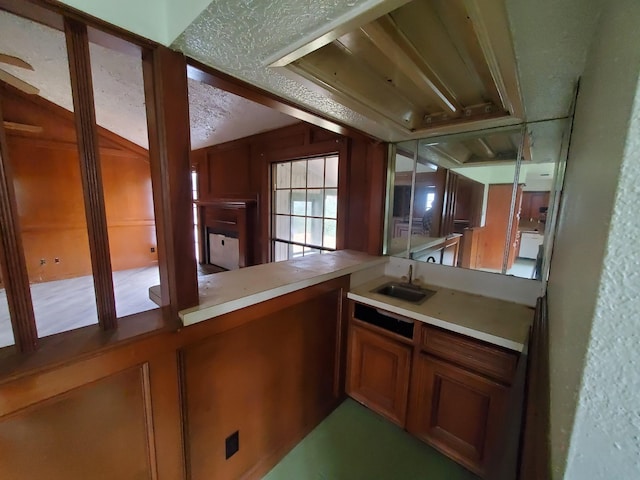 bar with sink and a textured ceiling