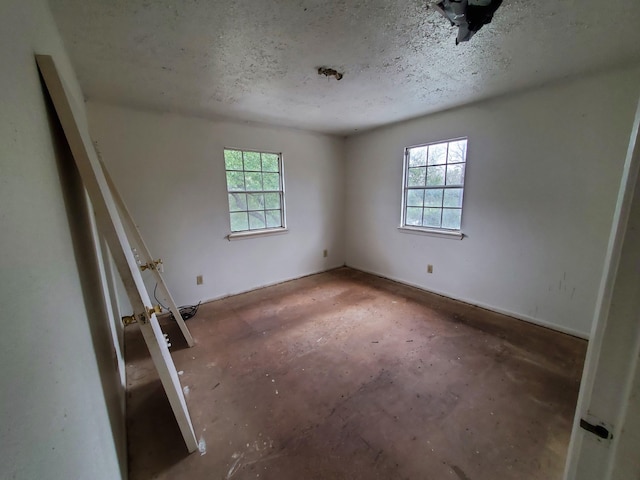 unfurnished bedroom with a textured ceiling