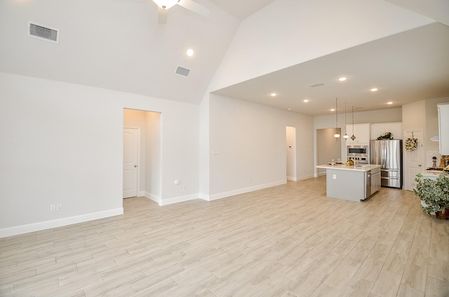 unfurnished living room featuring ceiling fan, high vaulted ceiling, and light hardwood / wood-style flooring