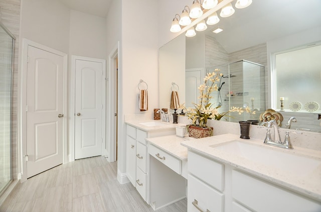 bathroom featuring vanity, a shower with door, and lofted ceiling