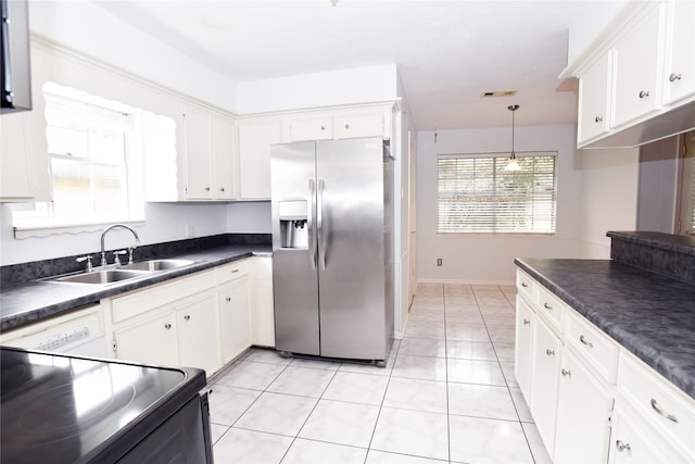 kitchen with sink, black electric range oven, stainless steel fridge, white cabinetry, and white dishwasher