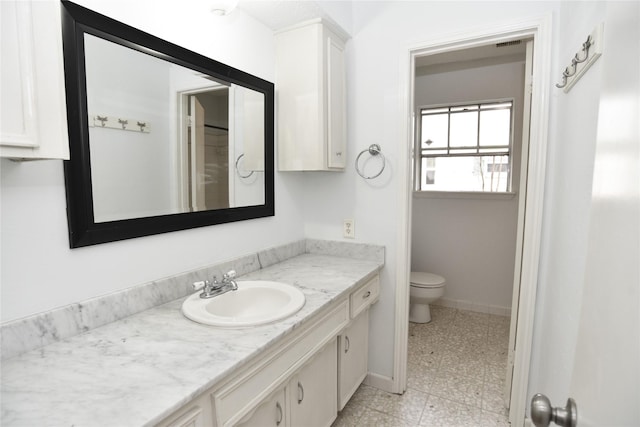 bathroom featuring vanity and toilet