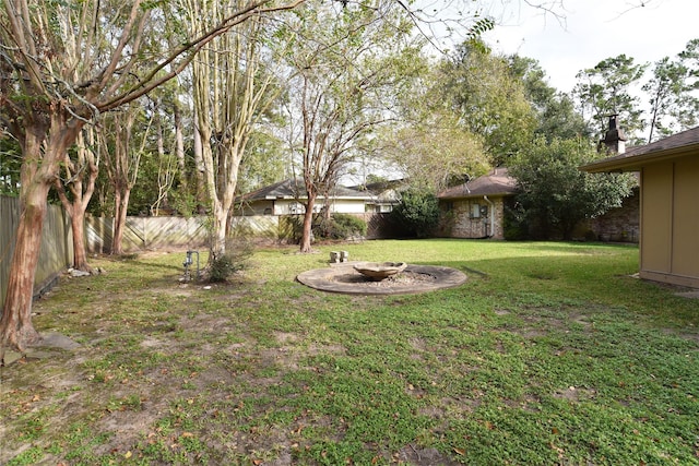 view of yard with a fire pit