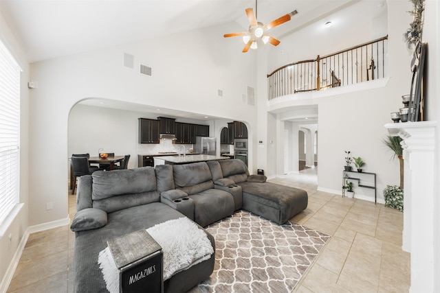 tiled living room featuring vaulted ceiling, sink, and ceiling fan