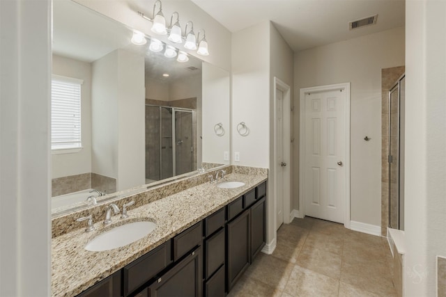 bathroom with tile patterned floors, vanity, and independent shower and bath