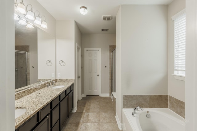 bathroom featuring tile patterned floors, vanity, and shower with separate bathtub