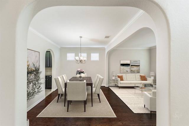 dining room with crown molding, a notable chandelier, and dark hardwood / wood-style flooring