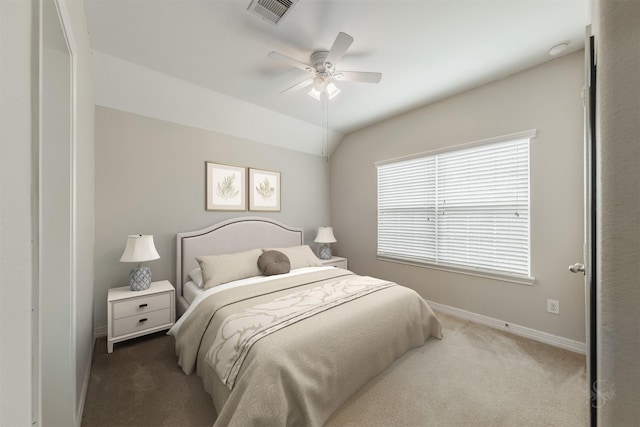 carpeted bedroom with vaulted ceiling and ceiling fan