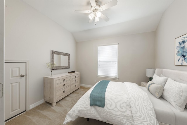 bedroom with ceiling fan, light colored carpet, and lofted ceiling