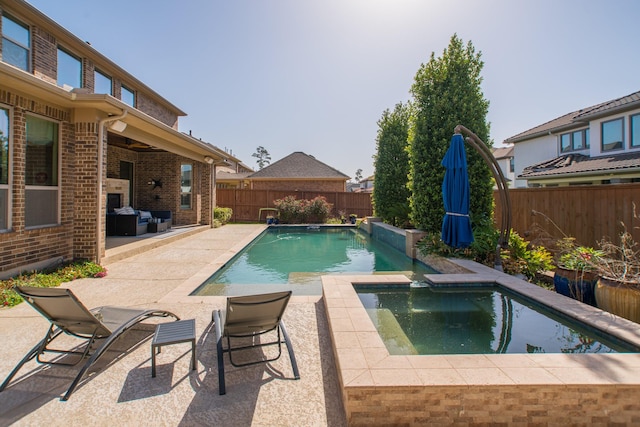 view of pool featuring area for grilling and a patio area