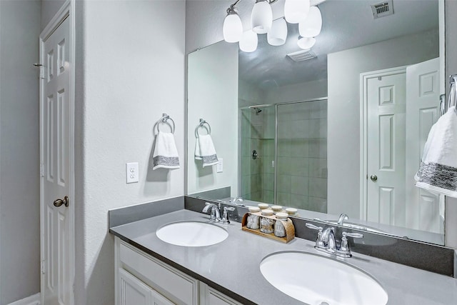 bathroom with vanity and a shower with shower door