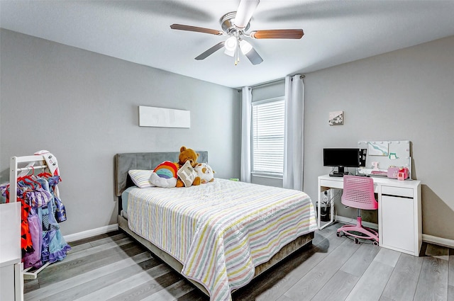 bedroom with light hardwood / wood-style flooring and ceiling fan