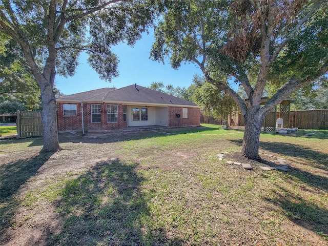 rear view of house featuring a lawn