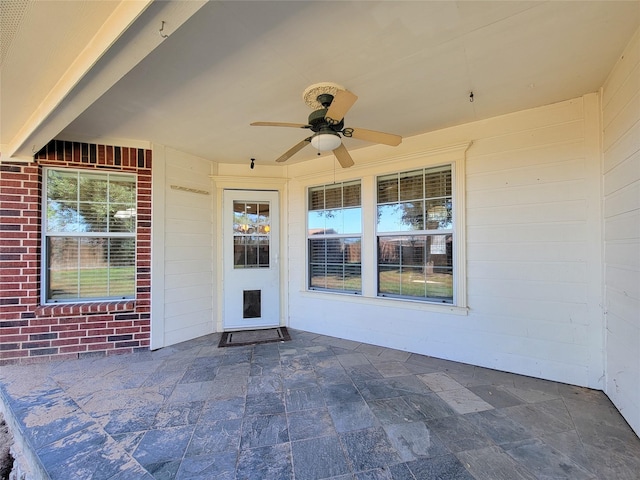 entrance to property featuring ceiling fan