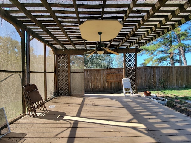 wooden deck with ceiling fan and a pergola