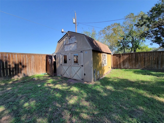 view of outbuilding featuring a yard