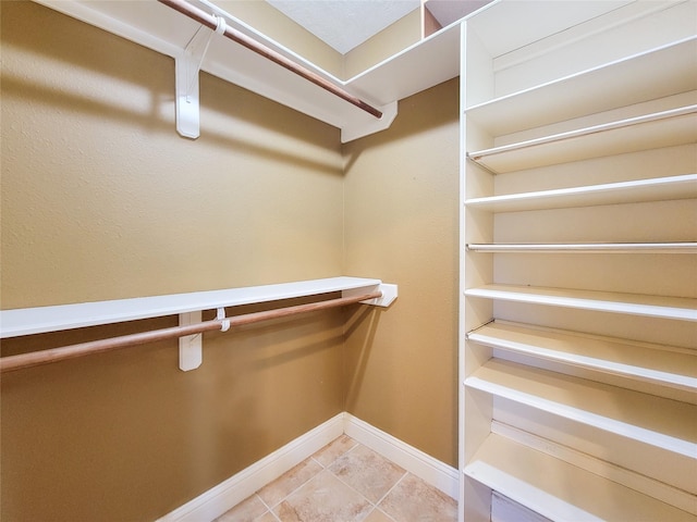 walk in closet featuring tile patterned flooring