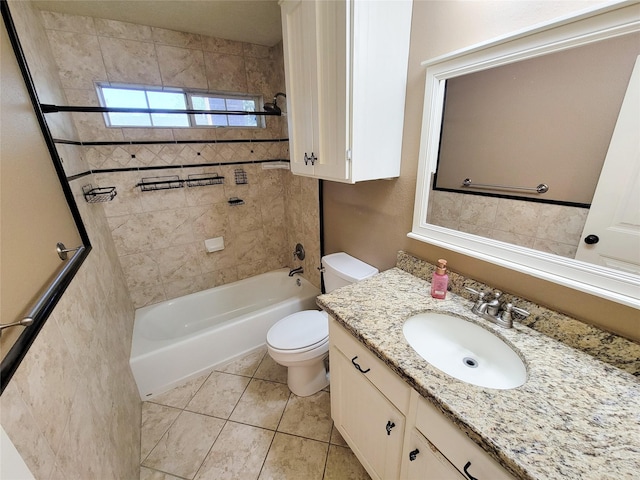 full bathroom featuring tiled shower / bath, vanity, toilet, and tile patterned floors