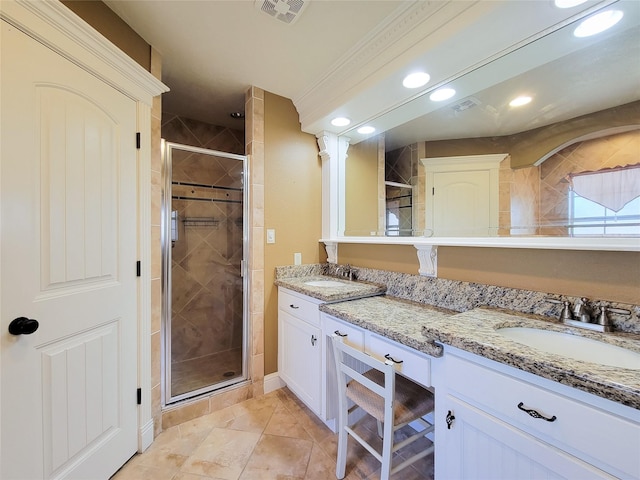 bathroom featuring vanity and an enclosed shower