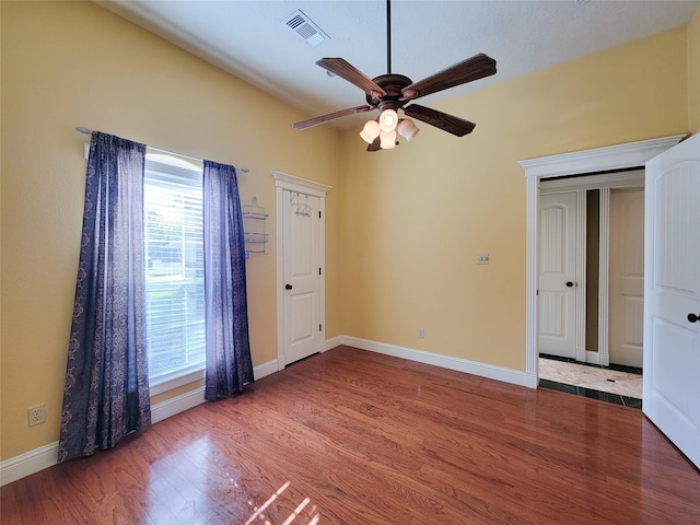 spare room featuring wood-type flooring and ceiling fan