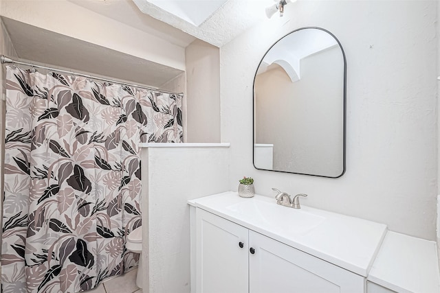 bathroom with vanity, toilet, and tile patterned flooring