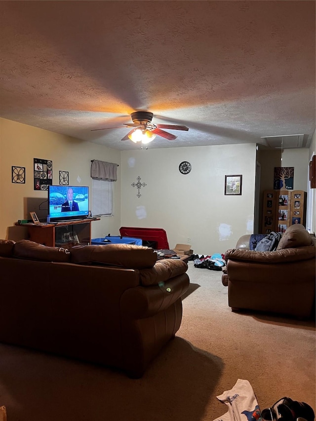 living room with ceiling fan, a textured ceiling, and carpet flooring