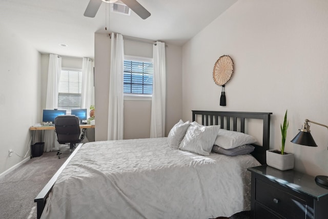 bedroom featuring ceiling fan, carpet floors, and multiple windows