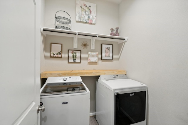 clothes washing area with separate washer and dryer