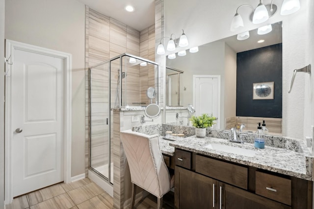 bathroom featuring vanity and an enclosed shower