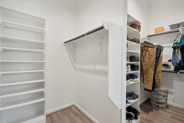 walk in closet featuring light hardwood / wood-style flooring