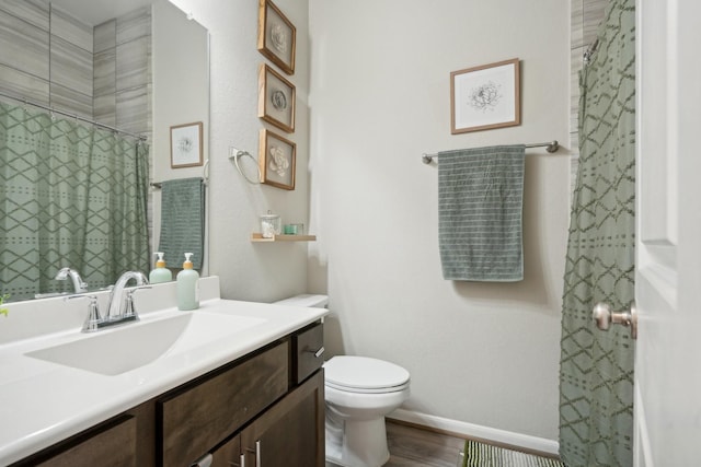 bathroom featuring vanity, a shower with curtain, toilet, and hardwood / wood-style flooring