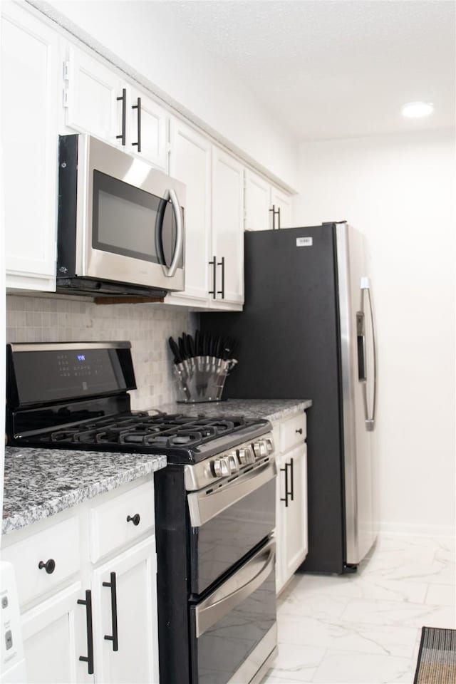 kitchen featuring appliances with stainless steel finishes and white cabinets