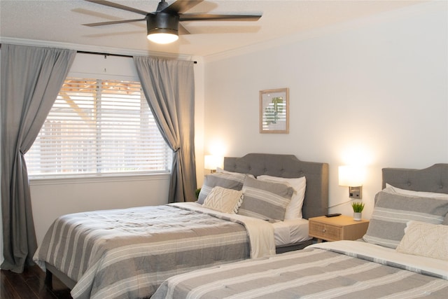 bedroom featuring crown molding, ceiling fan, and hardwood / wood-style floors