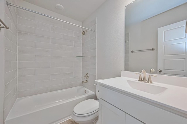 full bathroom with tiled shower / bath combo, vanity, and toilet