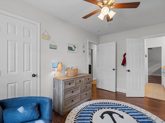 bedroom with dark hardwood / wood-style floors and ceiling fan