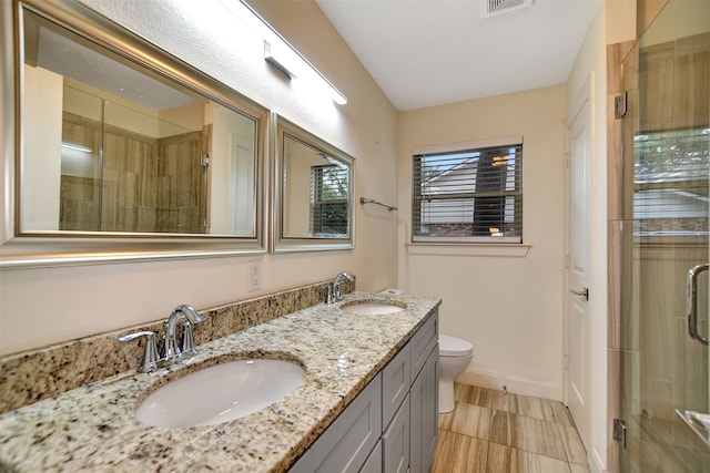 bathroom featuring walk in shower, vanity, and toilet