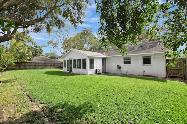 rear view of house featuring a yard