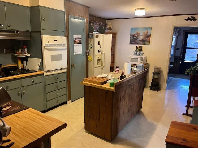 kitchen with white appliances and green cabinetry