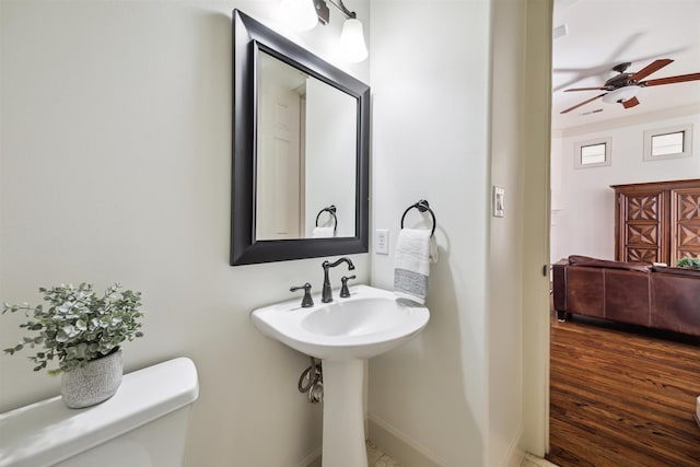 bathroom featuring sink, hardwood / wood-style floors, ceiling fan, and toilet