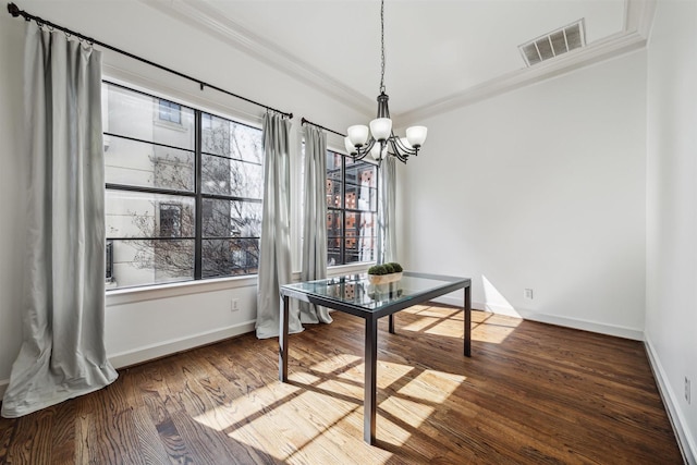 dining area with ornamental molding, a healthy amount of sunlight, a chandelier, and dark hardwood / wood-style flooring