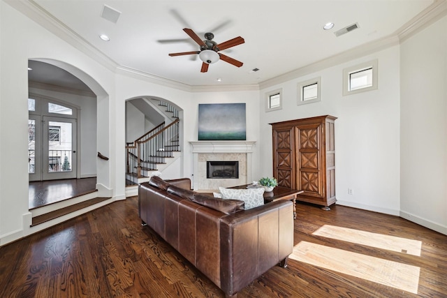 living room with dark wood-type flooring, ceiling fan, and ornamental molding