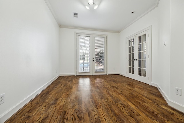 unfurnished room featuring dark hardwood / wood-style floors, ornamental molding, and french doors