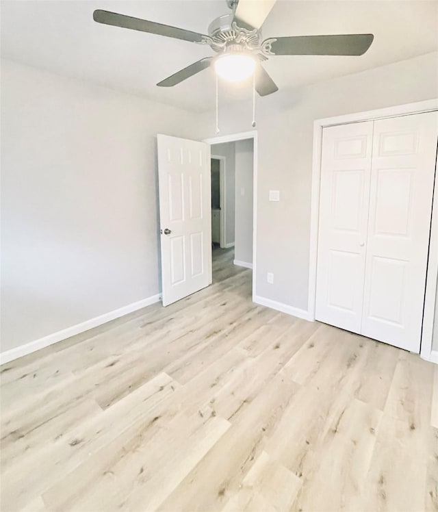 unfurnished bedroom featuring light hardwood / wood-style flooring, a closet, and ceiling fan