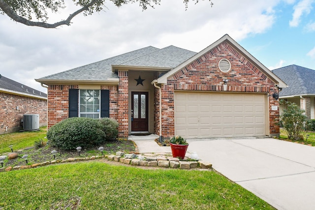 view of front of home featuring a garage, central AC, and a front lawn