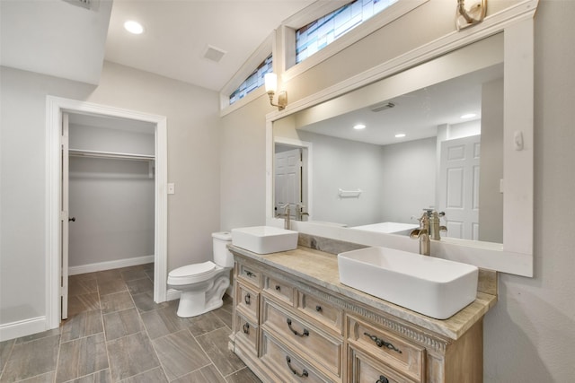 bathroom featuring toilet and vanity