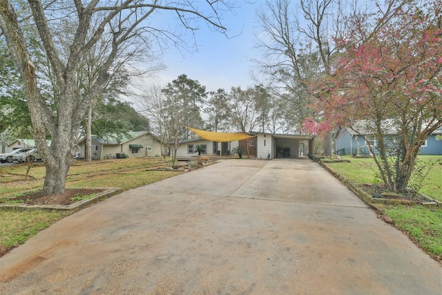 ranch-style home with a front lawn and a carport