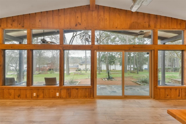 unfurnished sunroom with lofted ceiling and ceiling fan